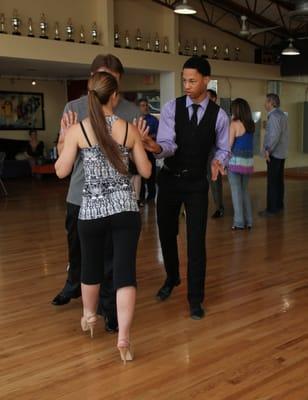 A young couple takes dance lessons to prepare for their first dance at their wedding.