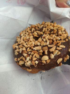 Chocolate covered with nuts bready donut