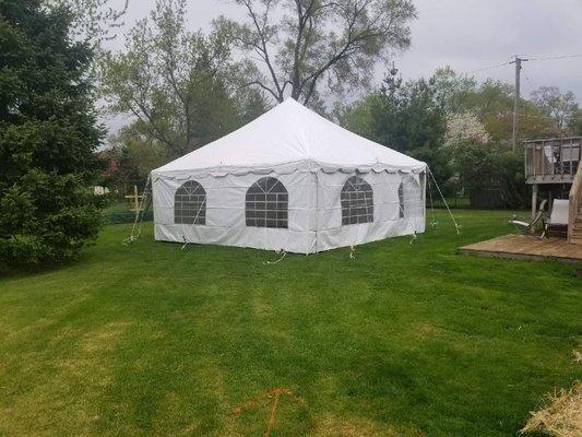 20x20 canopy pole tent set up in grass with side walls