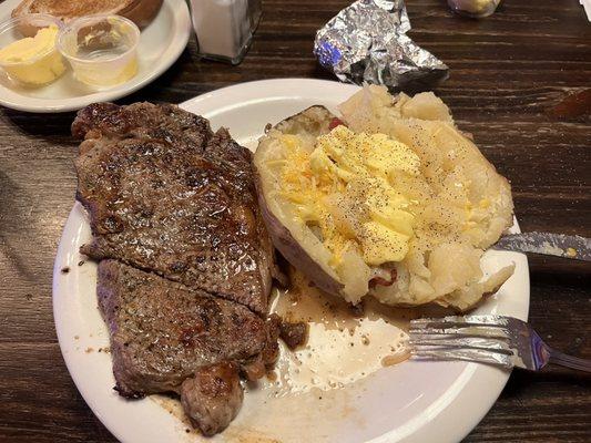 Ribeye steak and loaded baked potato