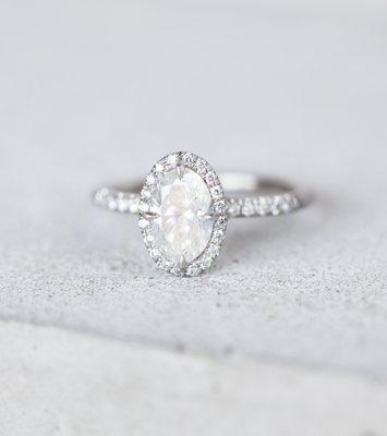 This platinum ring has a unique feature-- a slightly "milky" central diamond that adds a little mystery to an otherwise classic design.