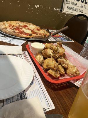 Wings and Italian pizza with anchovies