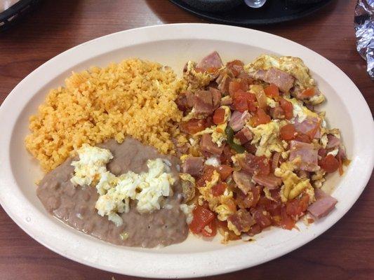 Eggs with ham tomatoes jalapeño, rice, beans and option of Mexican toast or tortillas- reminds me of breakfasts growing up