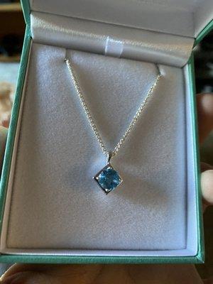 Custom Aquamarine necklace set in a rhodium-plated white gold housing with a silver chain.