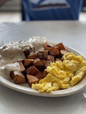 The sausage biscuits & gravy with home fries and scrambled eggs.