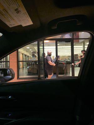 Picture of staff blocking door and some gym members.