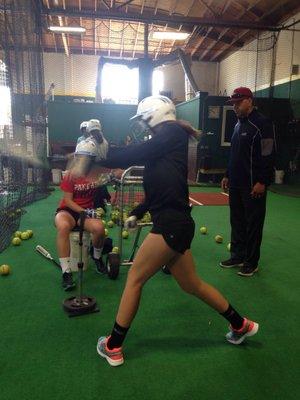 Coach Kevin instructing on hitting at The Cage