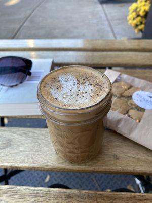 Black pepper and cardamom latte with vegan chocolate chip cookie