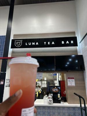 Strawberry sparkling tea with mango jelly in front of tea bar