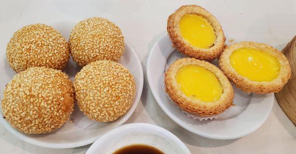 Sesame balls filled with red bean on the left Egg tarts on the right