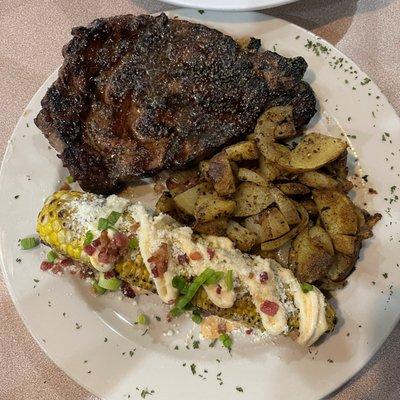 16 Oz Ribeye, fire corn, potatoes with onions.