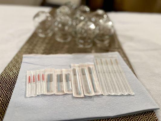 Acupuncture needles and glass cups for cupping therapy at our Atlanta Acupuncture practice.