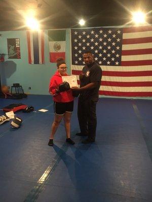 One of our kickboxers receiving her yellow belt