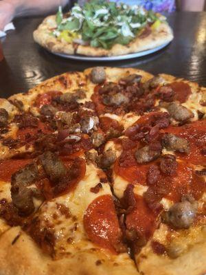 Carnivore pizza In foreground; special, Italian in background.