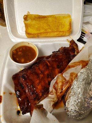 Full slab rib dinner w/baked beans and baked potato & garlic bread