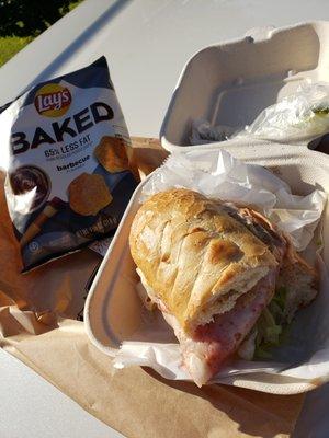 Small Italian Sub on white Bread with baked chips.