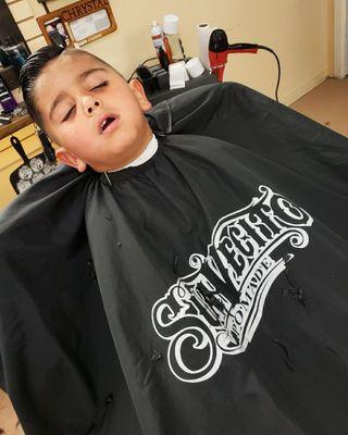 He enjoyed his haircut so much he fell asleep during the cut