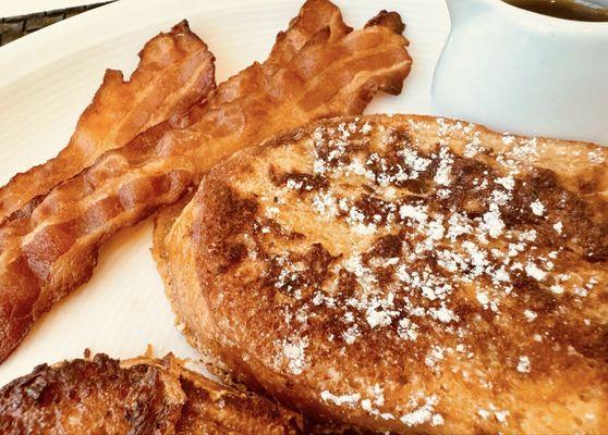 French toast with bacon and maple syrup. Also available: fresh fruit, muffins, cereals, bagels, coffee and tea.