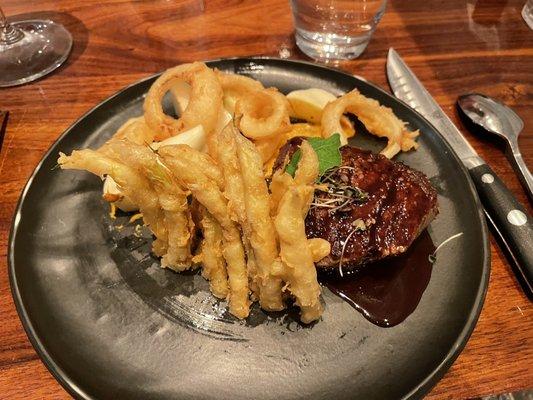 Filet mignon with onion rings and tempura wax beans