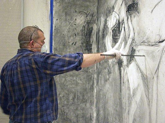 Artist drawing on the gallery walls for a special exhibition