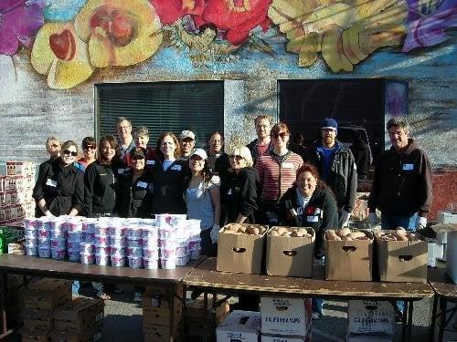 Our volunteer group assembles for a group photo prior to the food distribution. (photo courtesy of Robbi S)