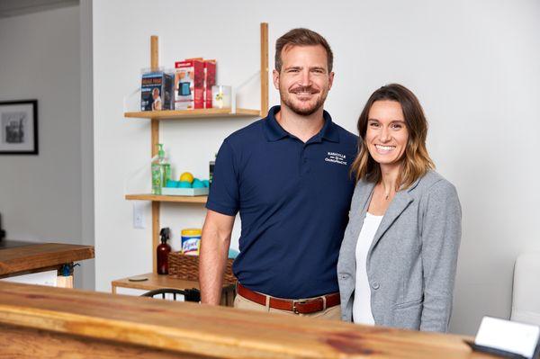 Drs. Ben & Lauren at the front desk of Nashville Chiropractic.