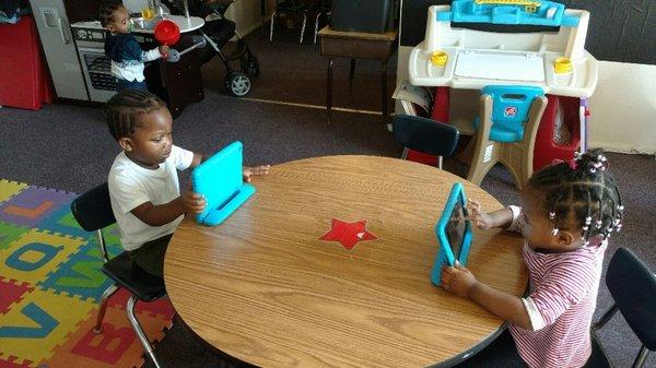 Pre- schooler doing work on Tablet