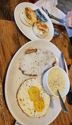 Chicken fried steak breakfast with two sides of choice: grits and biscuits. Deelish!