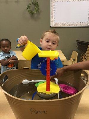 A simple pour station can teach so many STEAM concepts (gravity, cause+effect, etc), but this student just knows it's FUN!