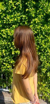 Hair color transformation from light golden brown to natural dark brown.