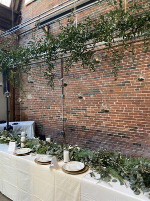 Hanging greenery and head table garland at Strongwater.