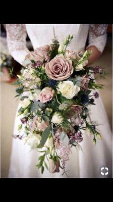 Lavender roses, ivory garden roses make this a gorgeous wedding bouquet