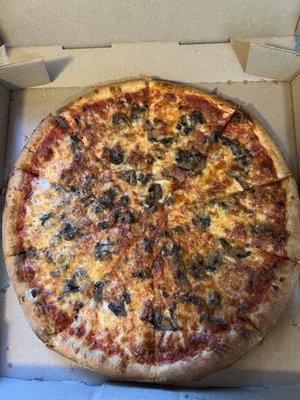 Large pizza with mushrooms and bacon