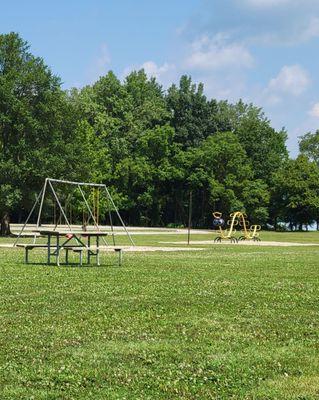 Swings, picnic table, and caterpillar climbing structure