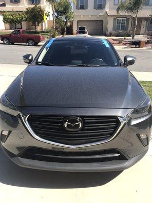 Front view Mazda C-3 windshield replacement.