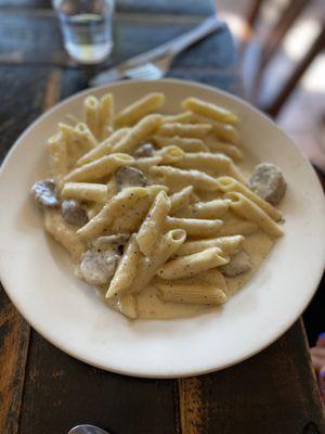 Penne pasta in Alfredo sauce with sausage