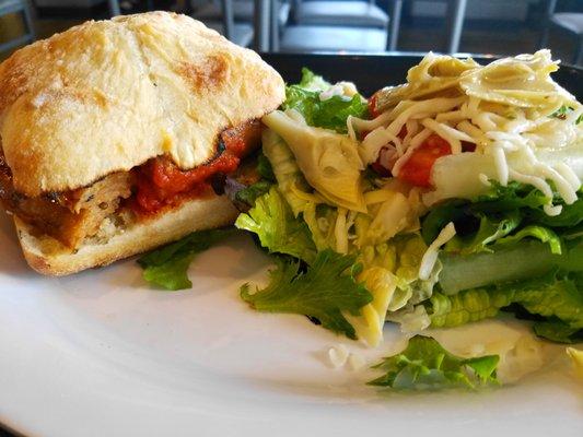 Italian sausage on ciabatta with a salad