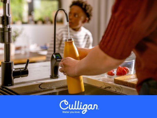 Woman filling water bottle with Culligan RO water