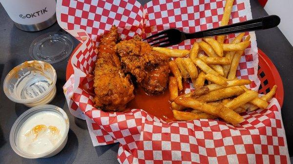 3 Chicken Tenders in Buffalo sauce with fries.