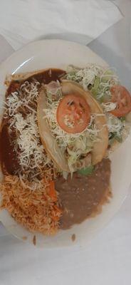 Carnitas and chicken taco and cheese enchilada combo plate