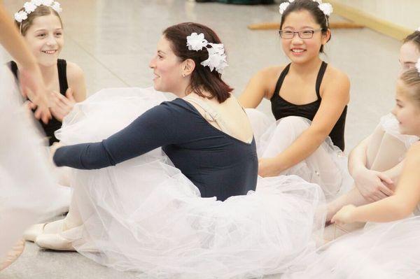 Ariel, a long-time ADI student mentoring young ballet students before a performance.