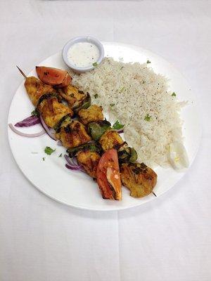 Chicken Kabob Entree comes with Rice, Salad and a side of Hummus and pita bread.