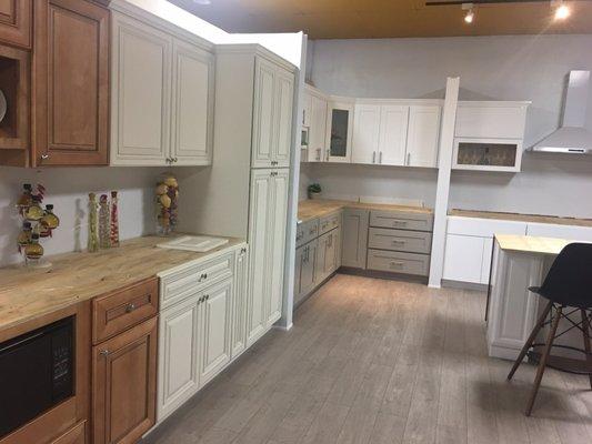 White, grey, and cream kitchen cabinets on display