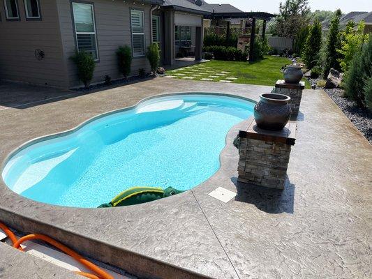 Stained concrete pool deck with slip resistant sealer.