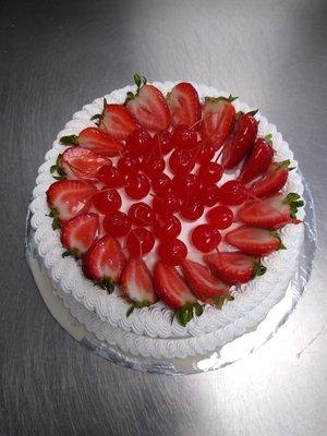 Tres Leches Pastel Con Fresas Y Cerezas, Tres Leches Cake with Topping of Strawberries and Cherries.