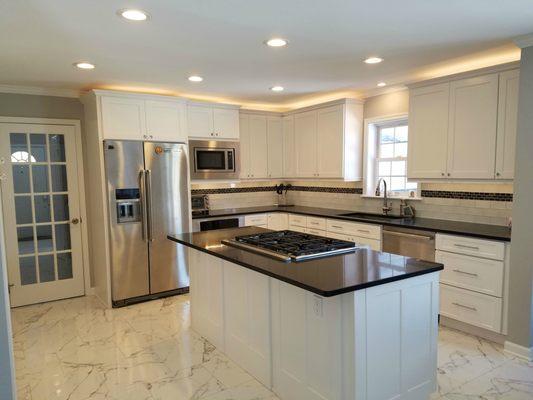 This kitchen Rose did in Darien, CT in 2017, with Carrara marble tiles and Silestone Starry Night quartz counters.