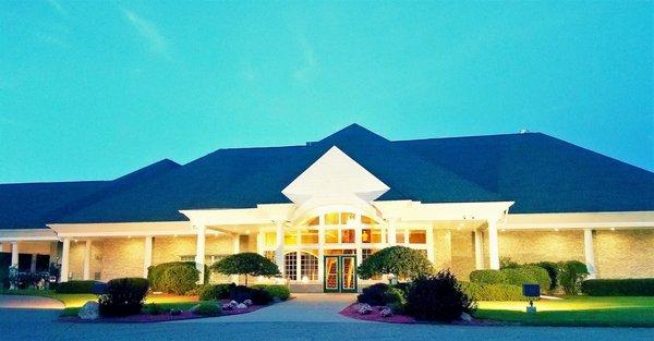 FRONT CLUBHOUSE ENTRANCE IN THE EVENING.