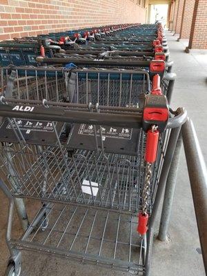 Locked shopping carts. Insert a quarter to unlock and you get it back when you return the cart.