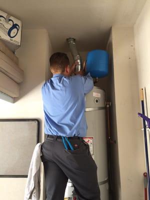 One of our technicians installing the vent and thermal expansion tank for a water heater.