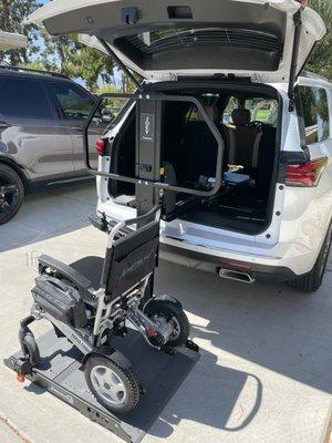 My electric wheelchair positioned to be automatically placed in the car's cargo area.